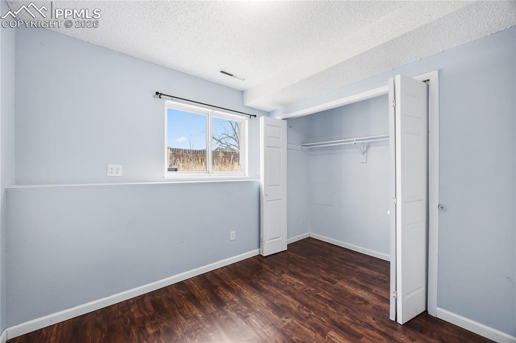 Image 19 of 27: Lower level bedroom #2 has LVP flooring and a generous closet.