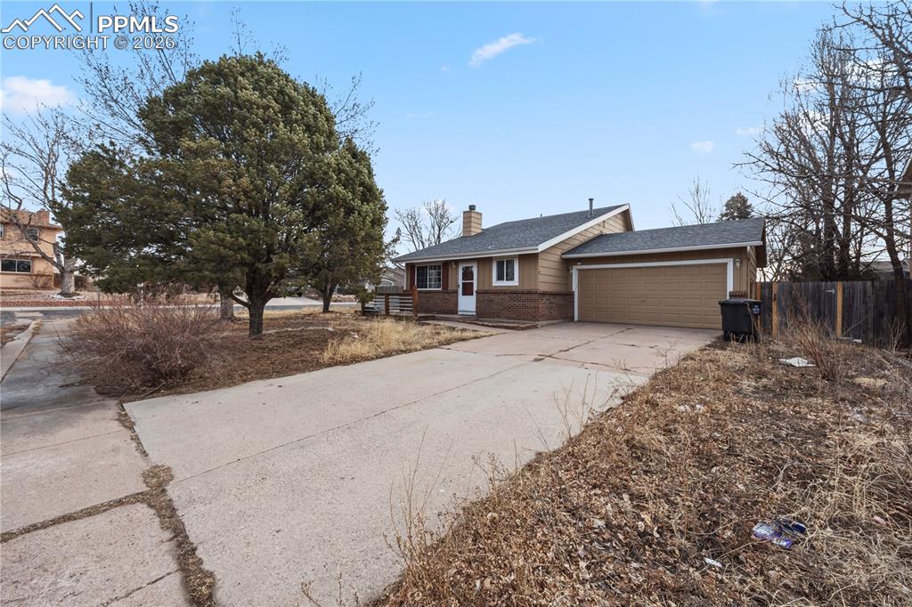 Image 3 of 27: 2-car attached garage with door opener, and workspace.