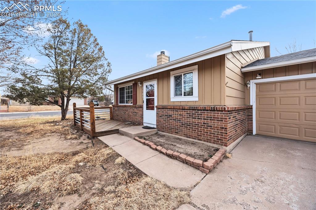 Image 4 of 27: Front walkway and small deck to enjoy the Colorado sunshine.