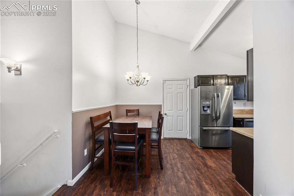 Image 8 of 27: Eat-in kitchen with a spacious dining area with attractive light fixture.