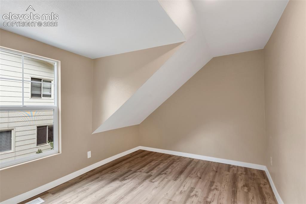Image 38 of 50: Room featuring wood-finish flooring and a window