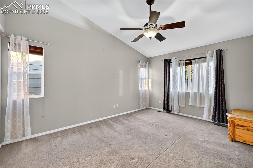 Image 16 of 41: Large primary suite, with vaulted ceiling, fan, bright widows on main floor