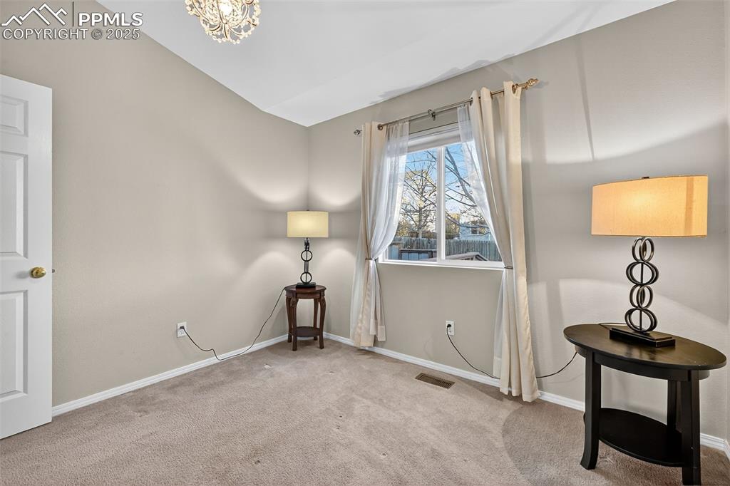 Image 23 of 41: Second main level bedroom, window blinds and curtains stay. 