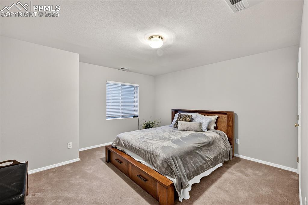 Image 28 of 41: Bedroom #3 in finished basement has large closet. 