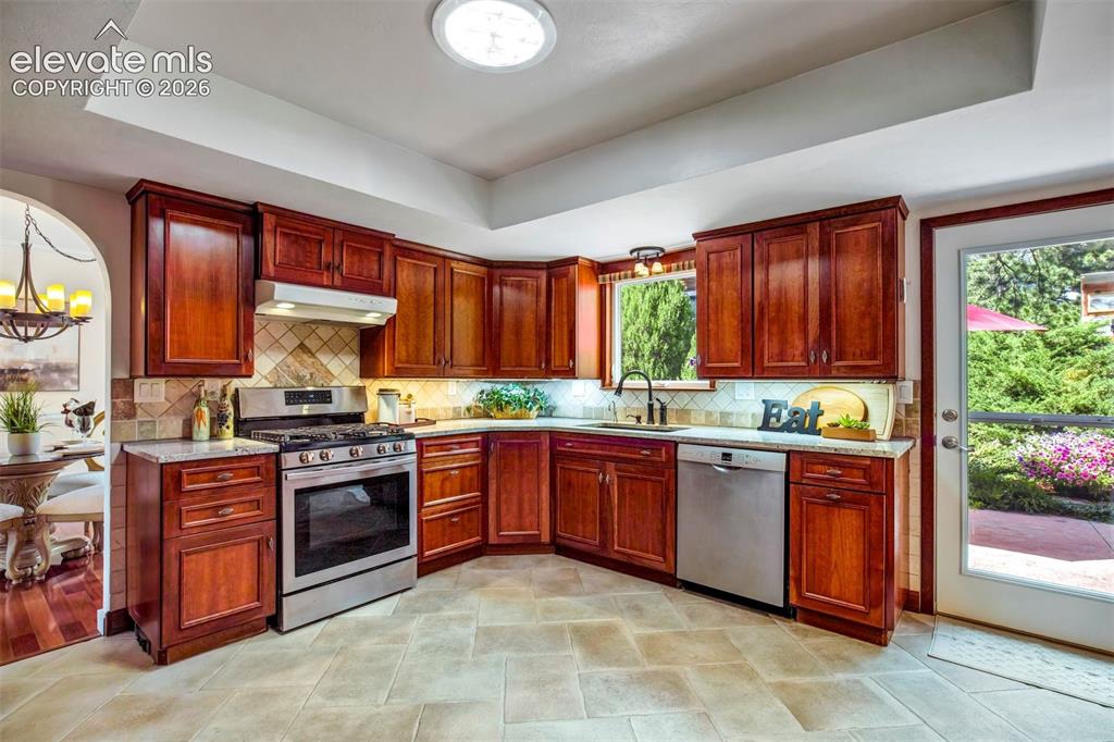 Image 17 of 48: Cherry Cabinets and Gas Range