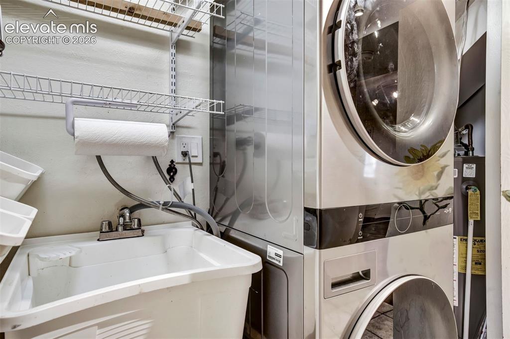 Image 36 of 48: Stacked Washer And Dryer With Laundry Sink, Lower Level