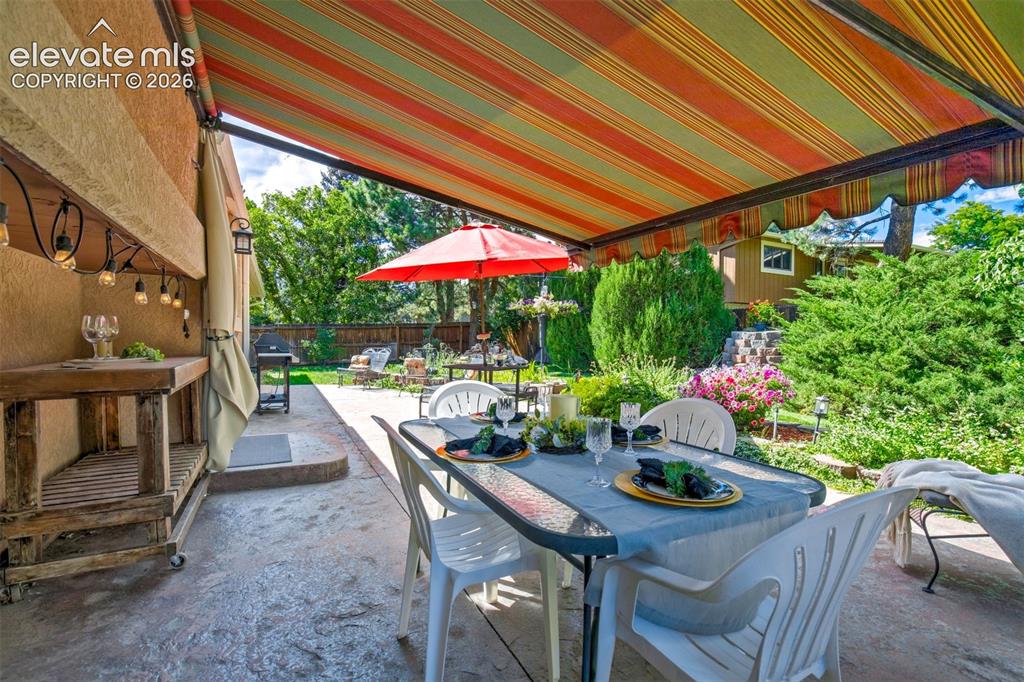 Image 37 of 48: Outdoor Dining Area Under Retractable Electric Awning