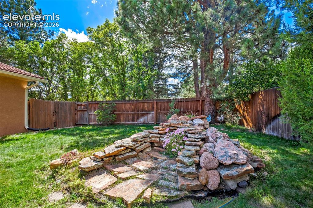 Image 41 of 48: Side Yard With Privacy Fencing And Mature Trees