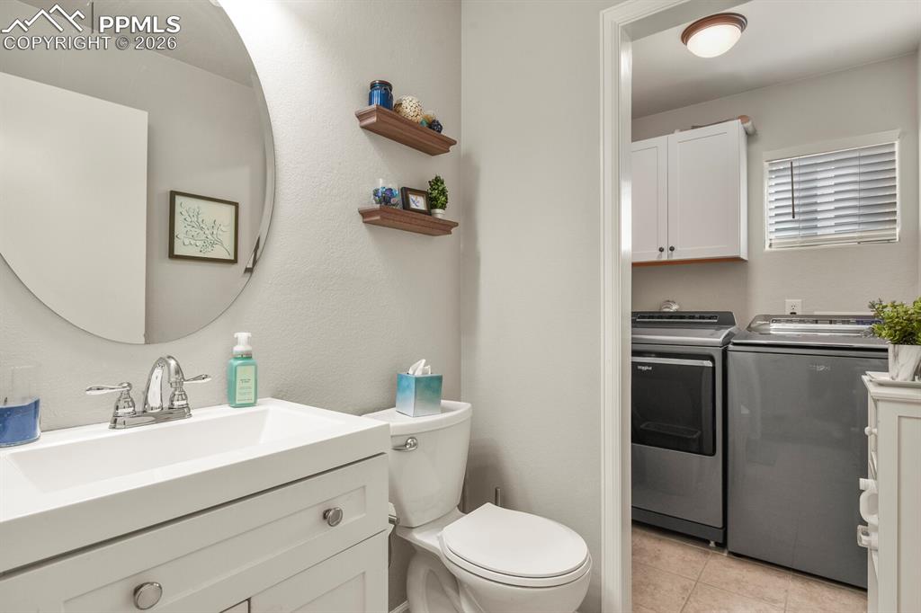 Image 22 of 43: Bathroom and laundry on the lower level.