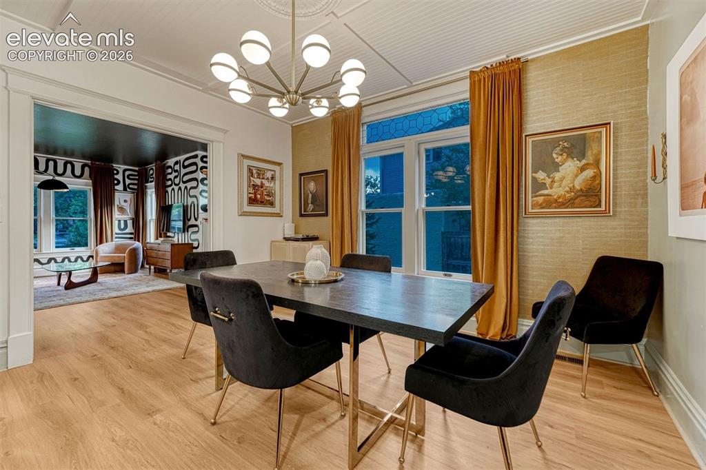 Image 20 of 50: Wood-finish flooring, decorative ceiling medallion, and a modern chandelier