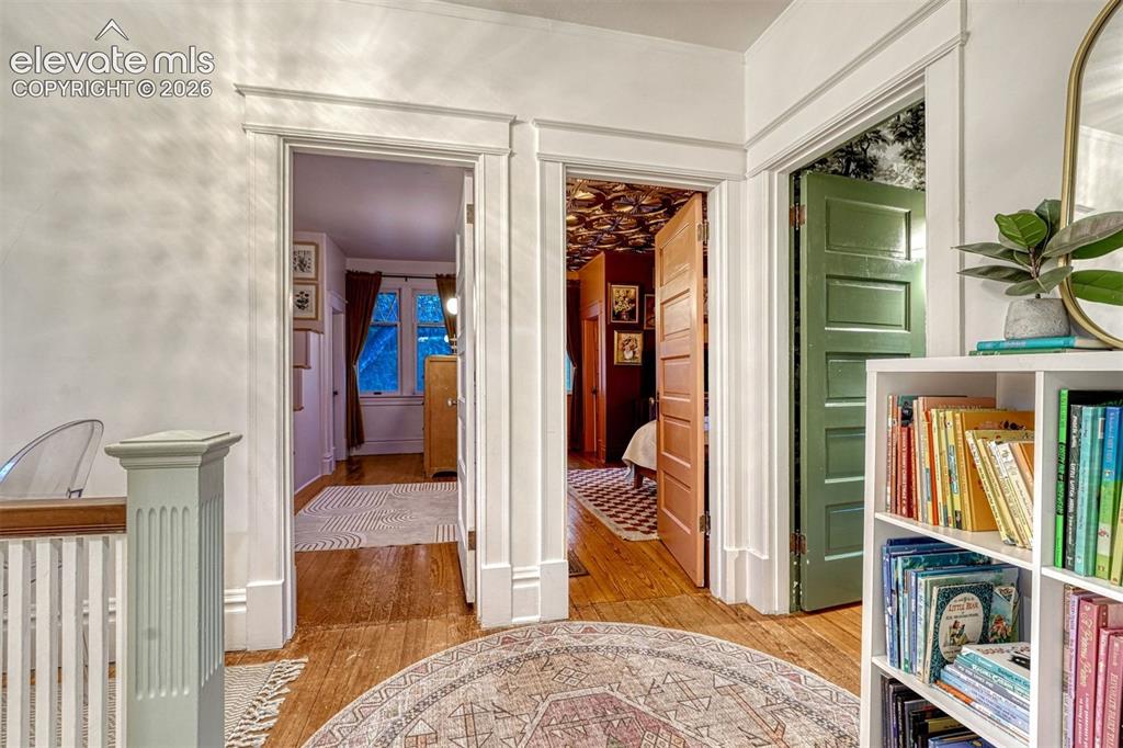 Image 35 of 50: Hardwood flooring, painted paneled doors, and detailed trim work