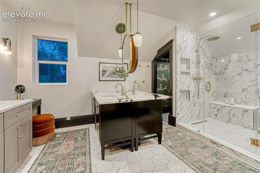 Image 4 of 50: Hexagonal tile flooring, dual vanity with undermount sinks, stone counterto