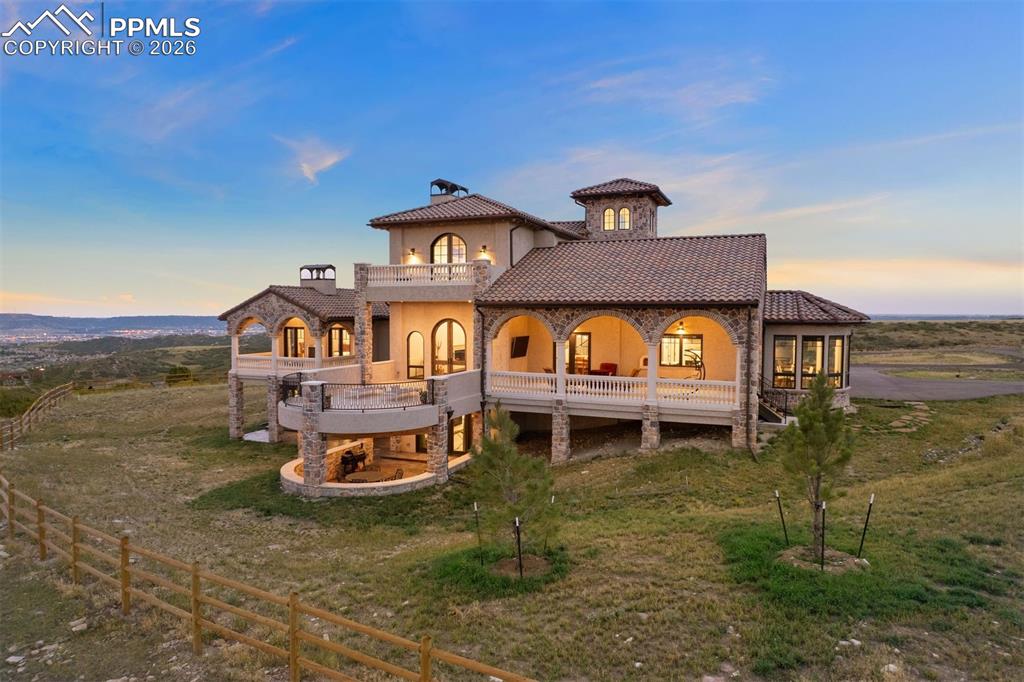 Image 11 of 39: Rear elevation at dusk showcasing the home