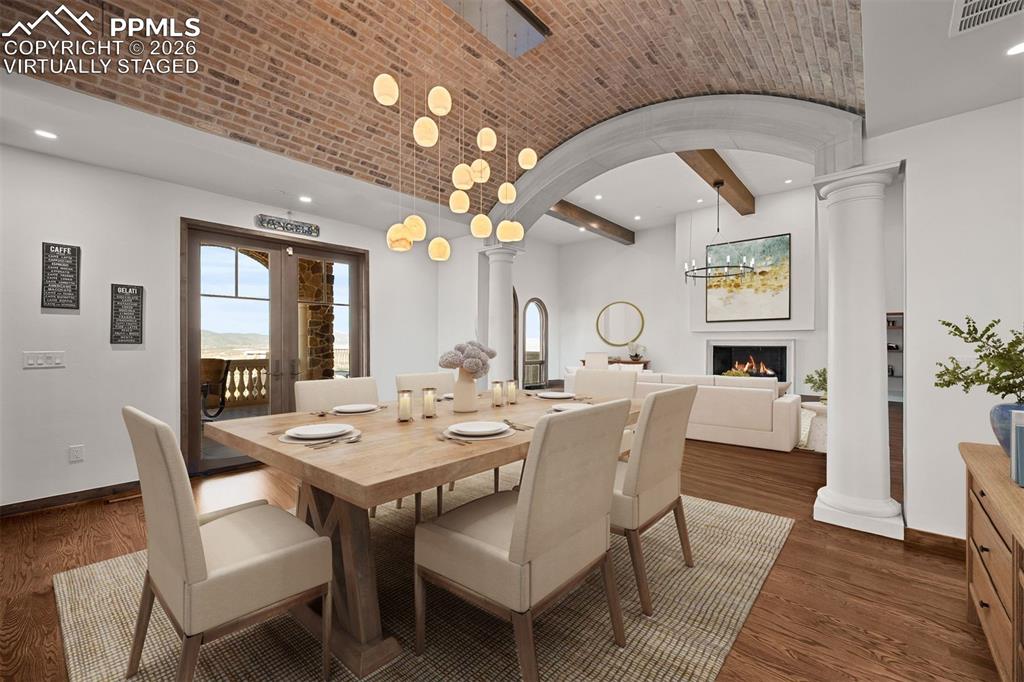 Image 15 of 39: Dining room features a brick barrel ceiling with Italian glass chandelier a