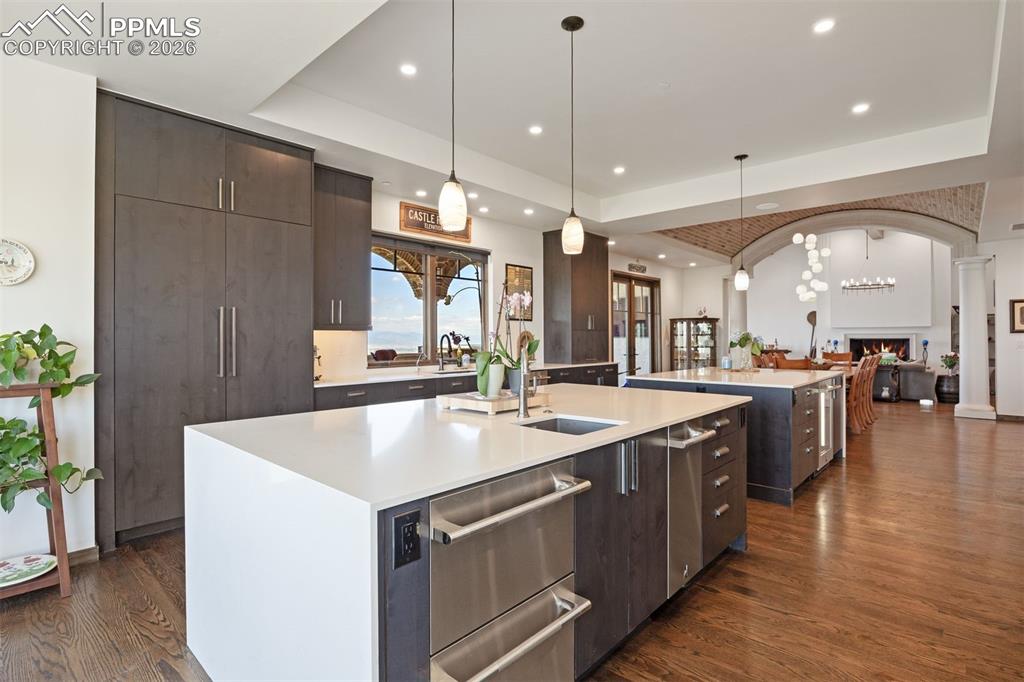 Image 17 of 39: Double waterfall quartz islands, floor-to-ceiling cabinetry, and JennAir ap