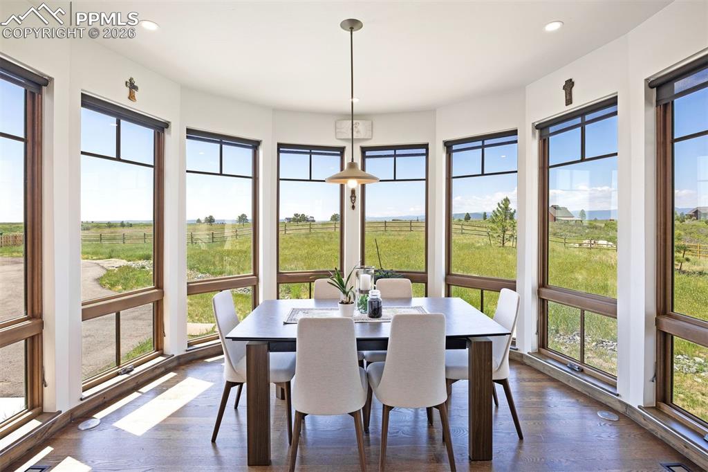 Image 20 of 39: Charming eat-in nook with curved bay windows and sweeping views of the open