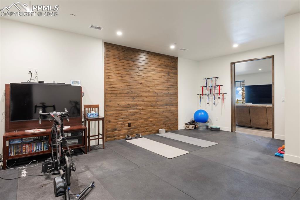 Image 29 of 39: Dedicated home gym with rubber flooring.