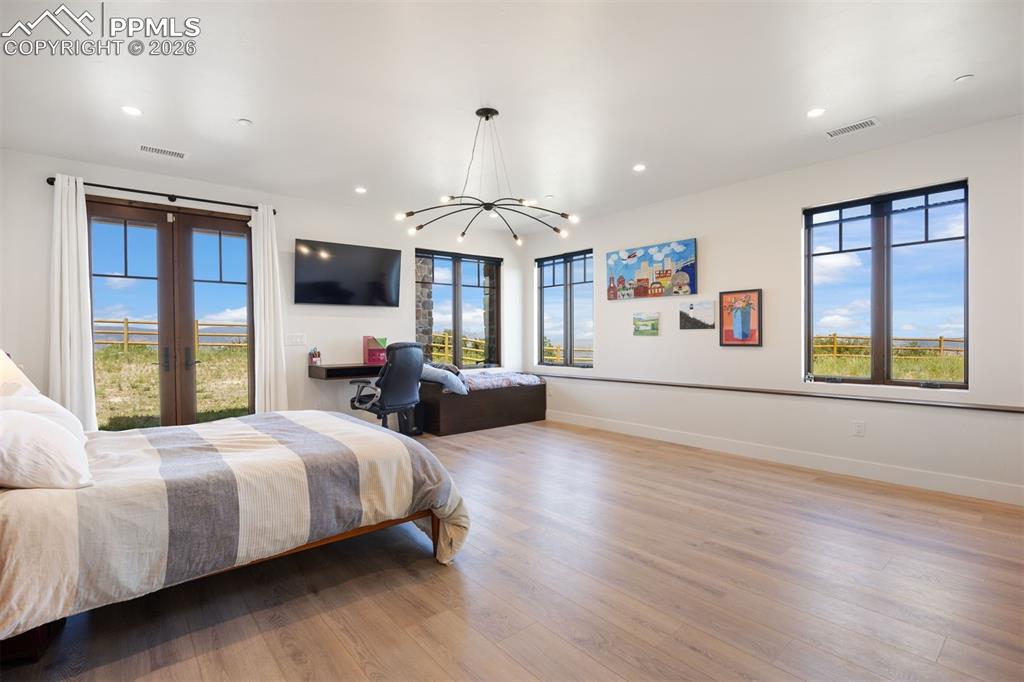 Image 31 of 39: Two bedrooms complete the lower level, and this one features a private walk