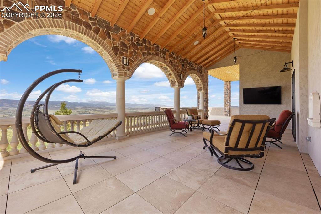 Image 33 of 39: Spacious covered deck with curved viewing balcony.