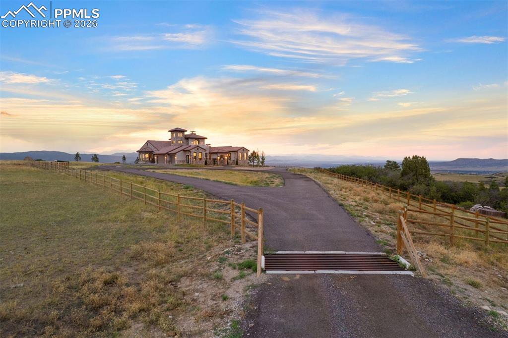 Image 38 of 39: Golden hour light pours over the hilltop setting,accentuating the circular