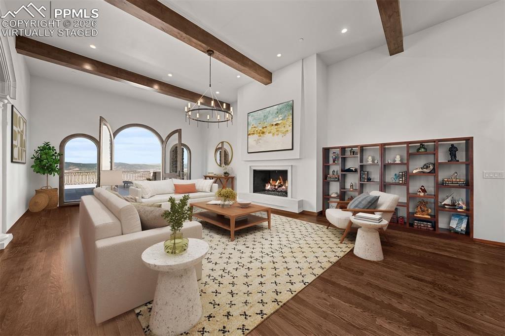 Image 4 of 39: The great room is anchored by a modern cast concrete fireplace, and just lo