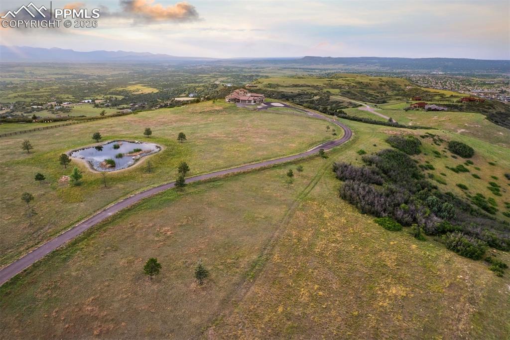 Image 7 of 39: Aerial view of the full 35-acre property, private pond, and winding drive l