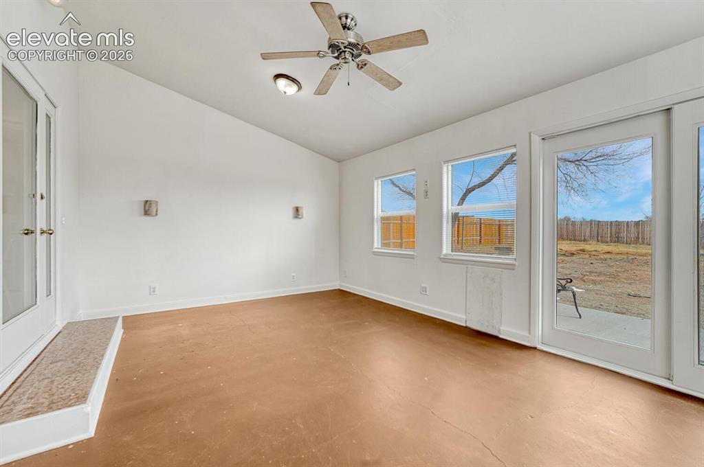 Image 14 of 42: Finished and heated sunroom with walkout to backyard. So many possibilities