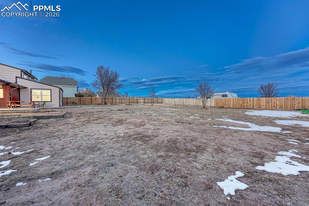 Image 16 of 42: A portion of the 2.5 acres has a privacy fence but the property goes beyond