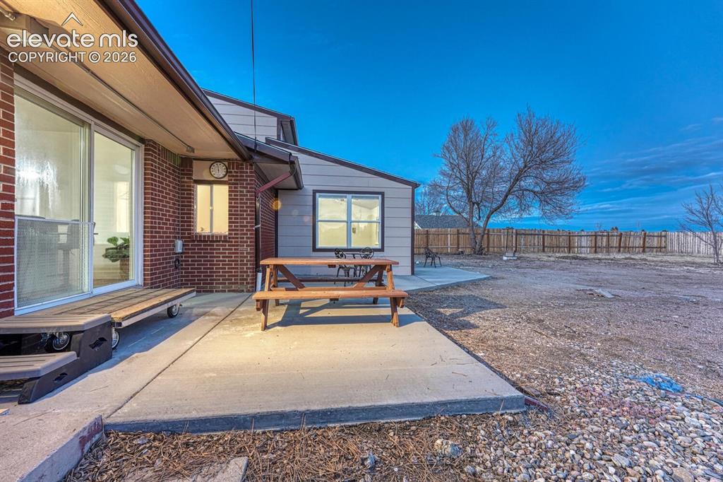 Image 16 of 42: New concrete patio and walkway right off the kitchen.