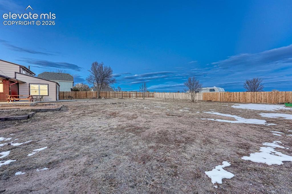 Image 17 of 42: A portion of the 2.5 acres has a privacy fence but the property goes beyond