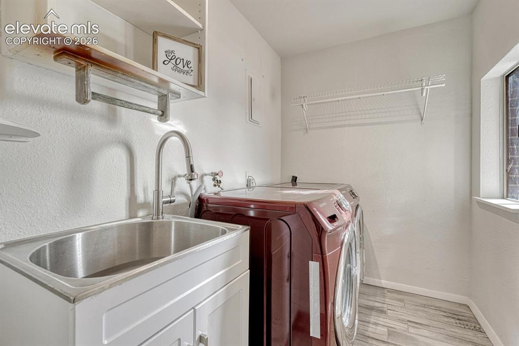 Image 25 of 42: Laundry room with sink and window