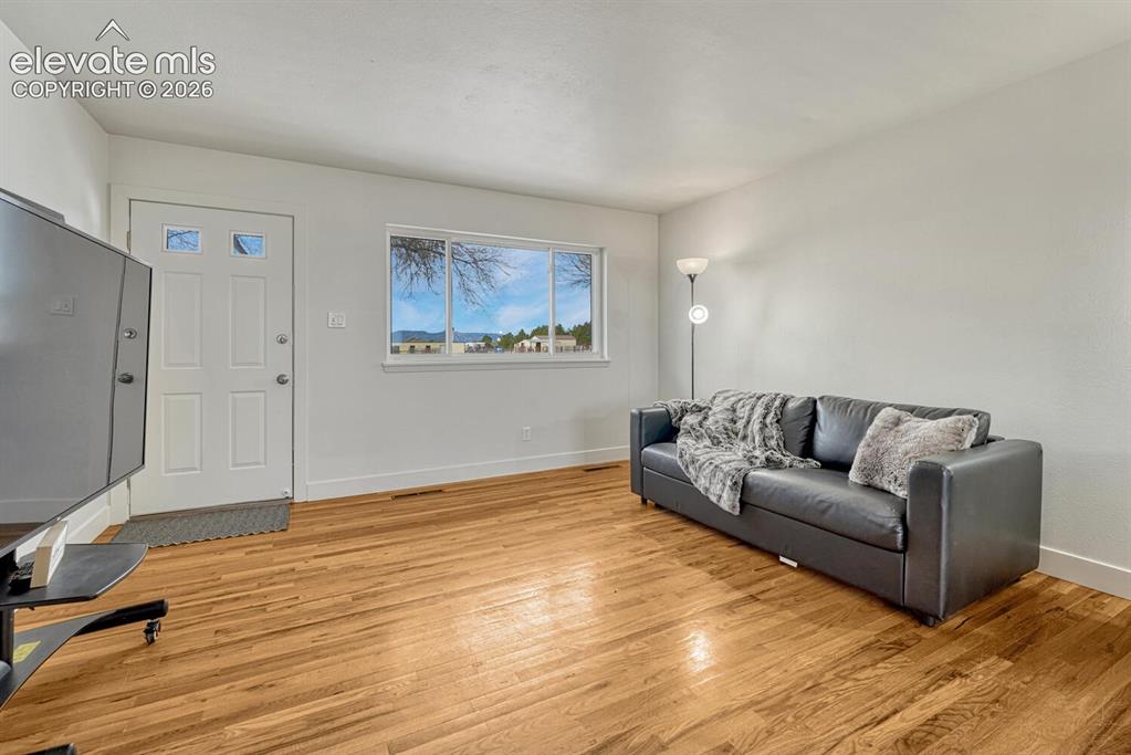 Image 26 of 42: Second entrance and living room on south side of the home. Mountain views!