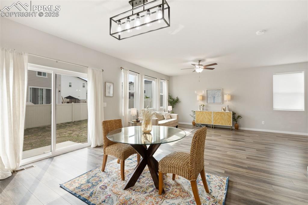 Image 11 of 26: Dining room with wood finished floors and baseboards