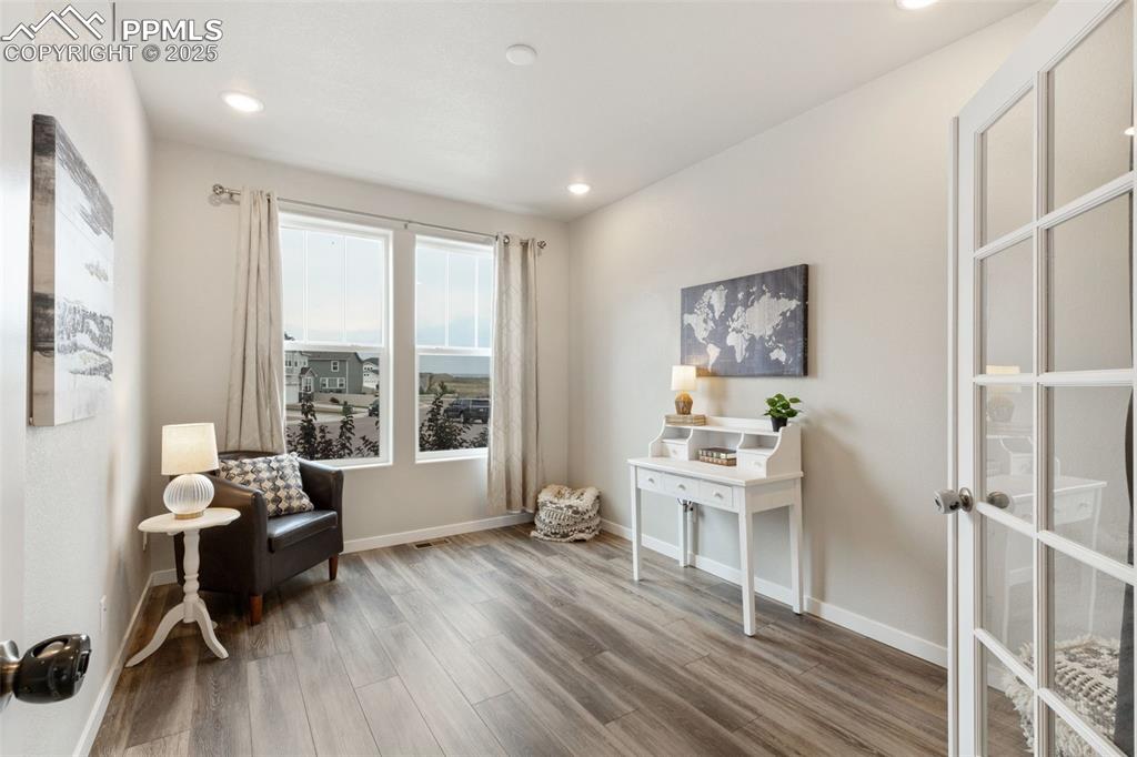 Image 12 of 26: Sitting room with light wood-type flooring and recessed lighting