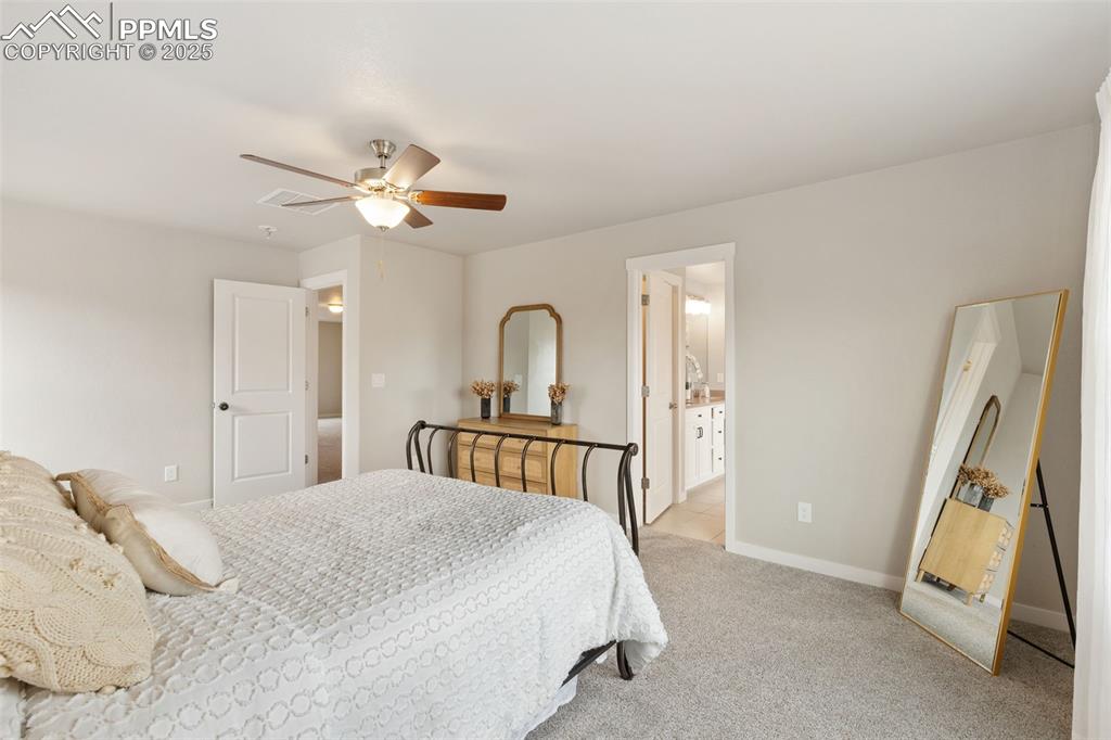 Image 17 of 26: Carpeted bedroom with baseboards and a ceiling fan