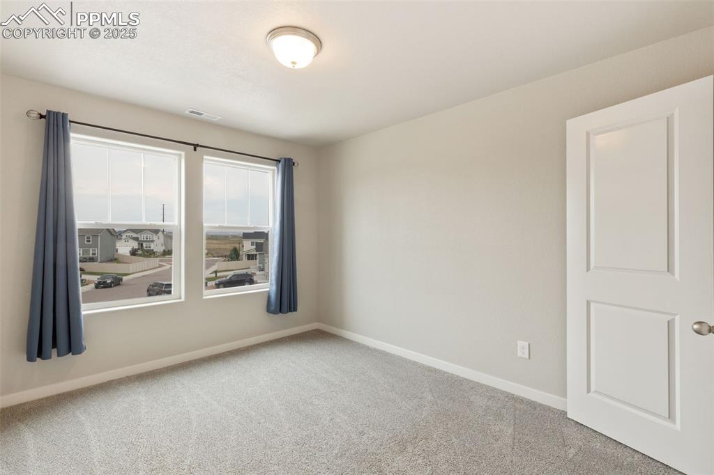 Image 21 of 26: Additional room featuring baseboards and light carpet