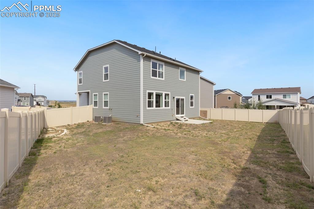 Image 27 of 28: Rear view of house featuring a patio area and a fenced backyard
