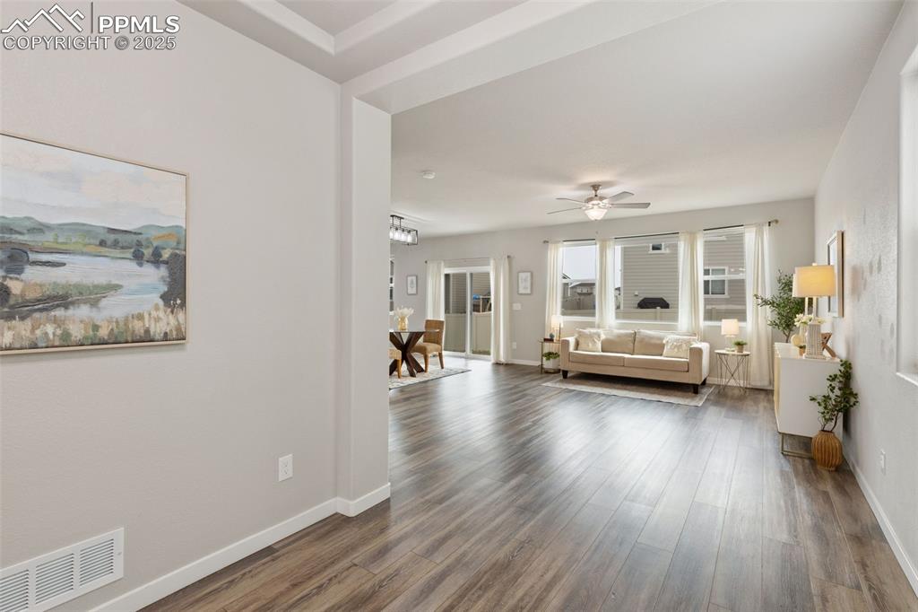 Image 3 of 26: Living room featuring luxury vinyl floors, tons of light, and ceiling fan
