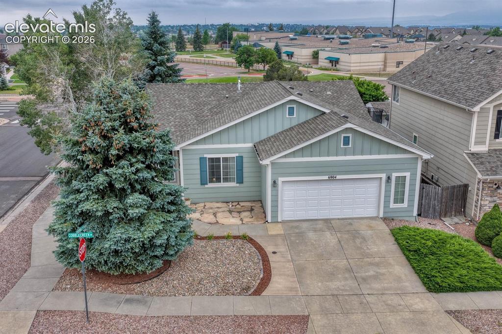 Image 10 of 50: Exceptional curb appeal features a thoughtfully xeriscaped yard, mature tre