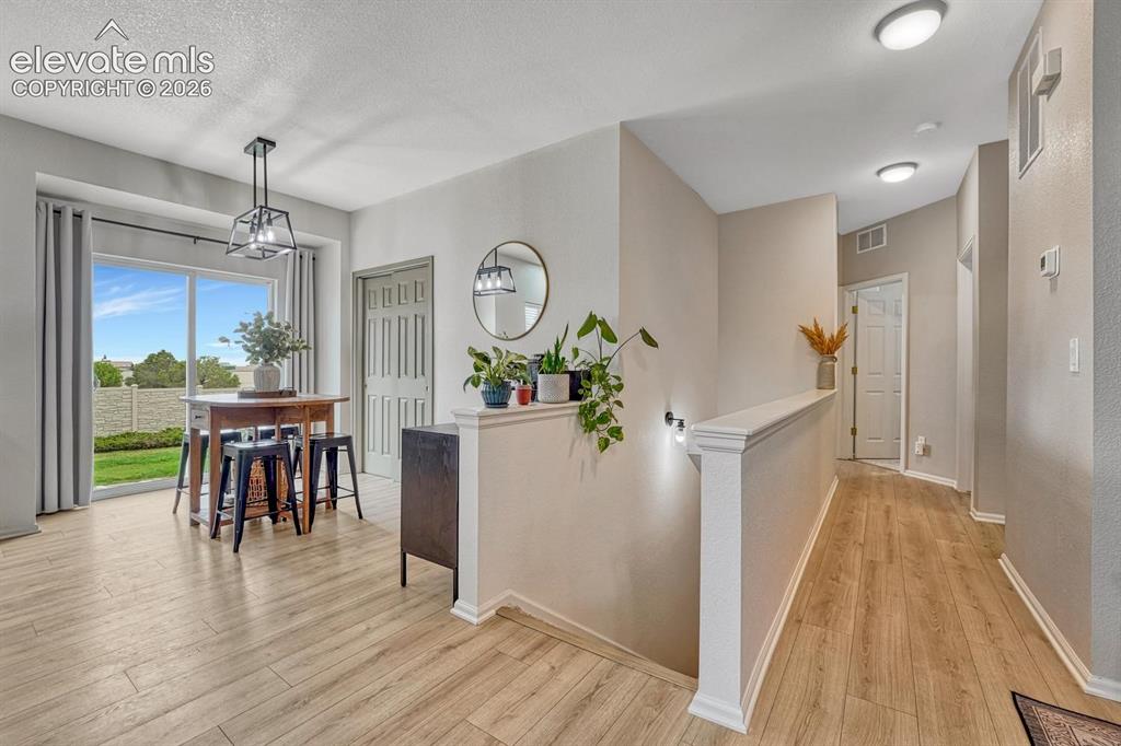 Image 17 of 50: Dining Area with views of stairs to the Unfinished Basement, and hallway to