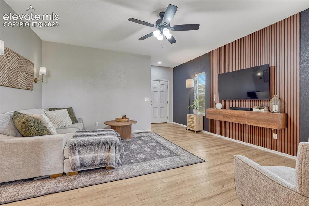 Image 3 of 50: The spacious living room blends warmth & contemporary style with wood accen