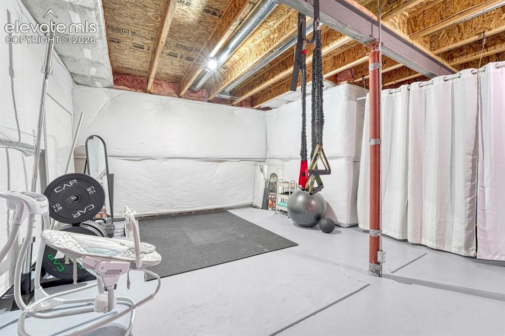 Image 38 of 50: Create your own home gym in the unfinished basement.