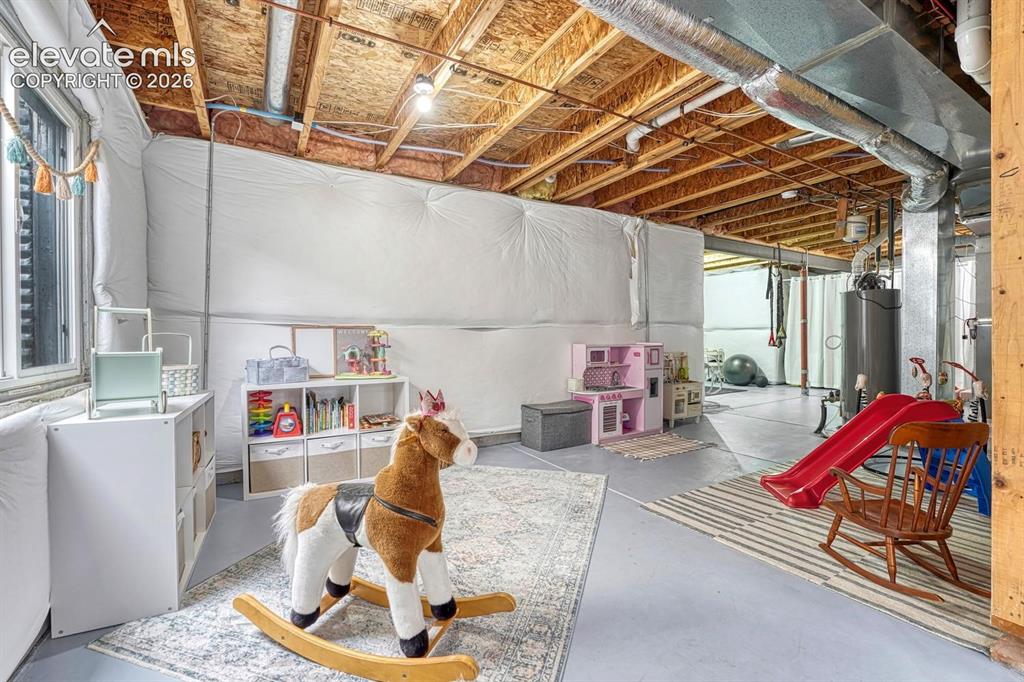 Image 39 of 50: The unfinished basement has space for an awesome play room or craft room fo