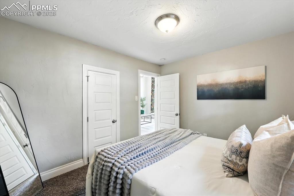 Image 16 of 36: Carpeted bedroom featuring baseboards and a textured ceiling