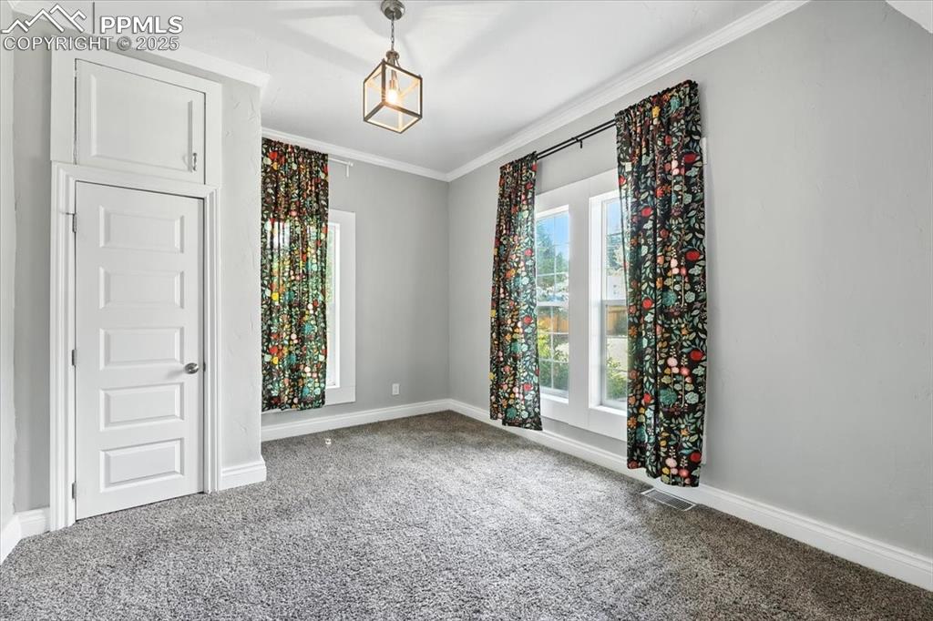 Image 21 of 36: Empty room featuring carpet flooring and crown molding