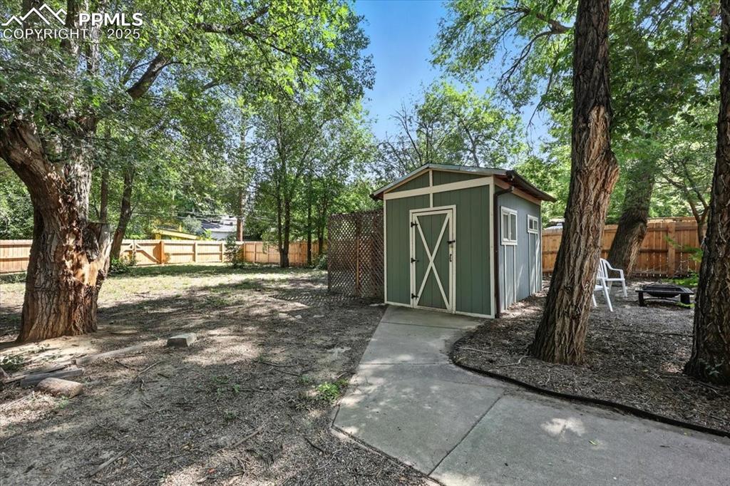 Image 27 of 36: View of shed with a fenced backyard