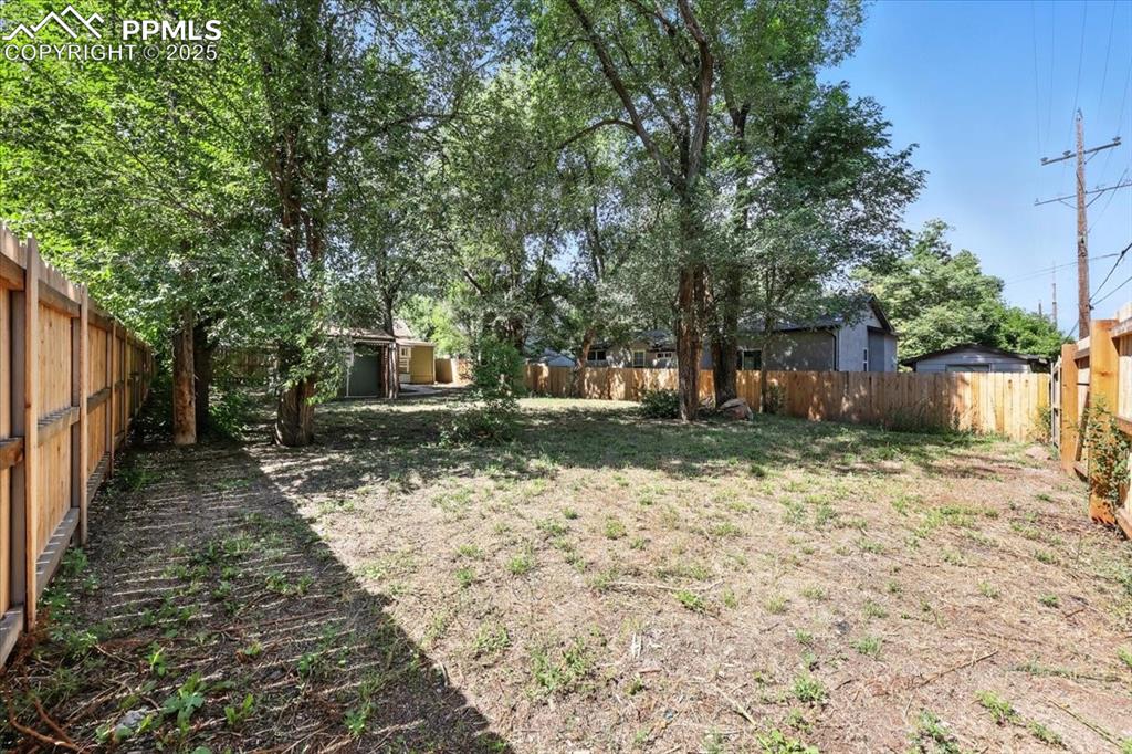 Image 31 of 36: View of fenced backyard