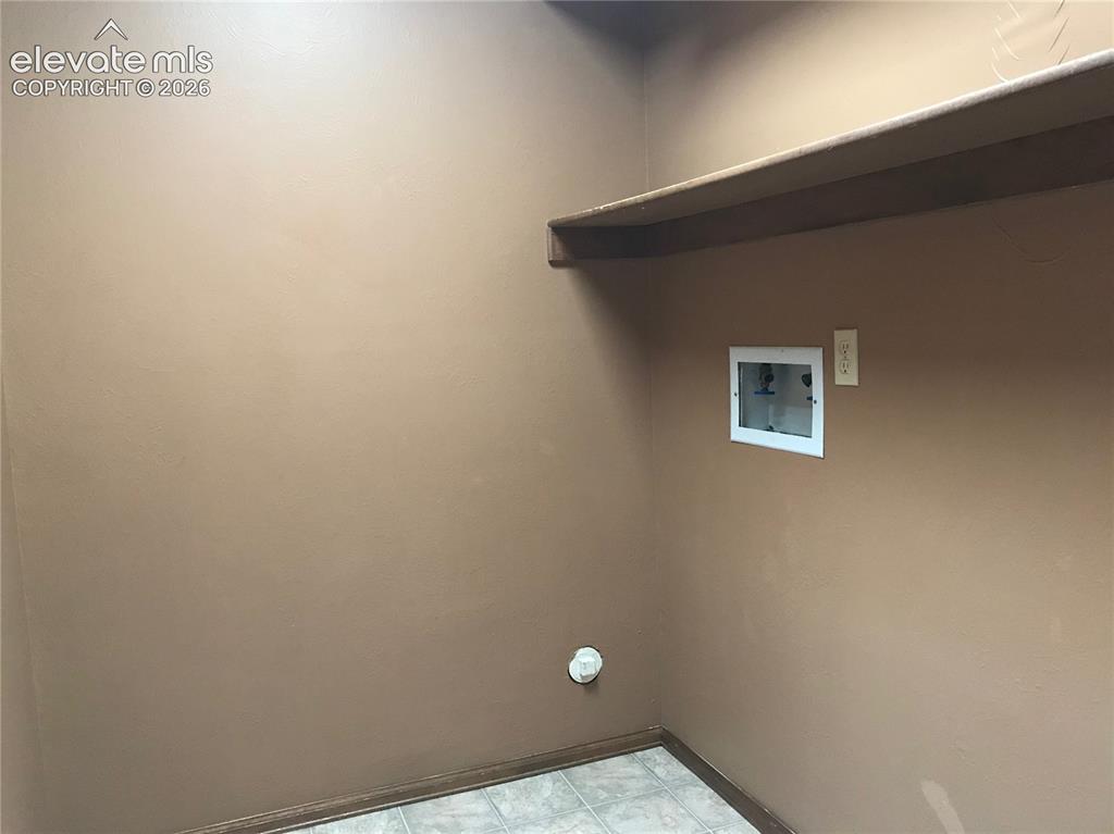 Image 15 of 35: Laundry area featuring a utility hookup, neutral wall paint, a built-in she