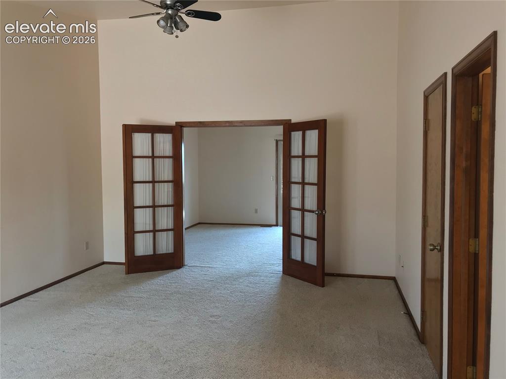 Image 27 of 35: Interior space featuring a vaulted ceiling and a ceiling fan with integrate