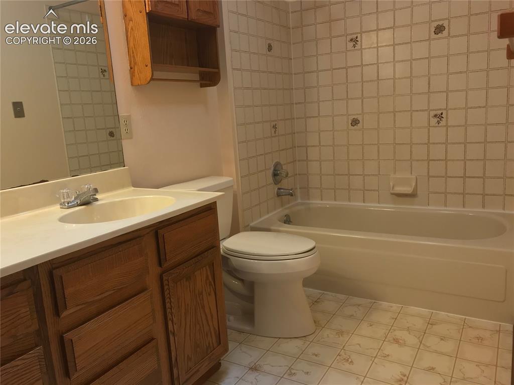 Image 29 of 35: Bathroom featuring a wood-finish vanity with a white countertop and integra